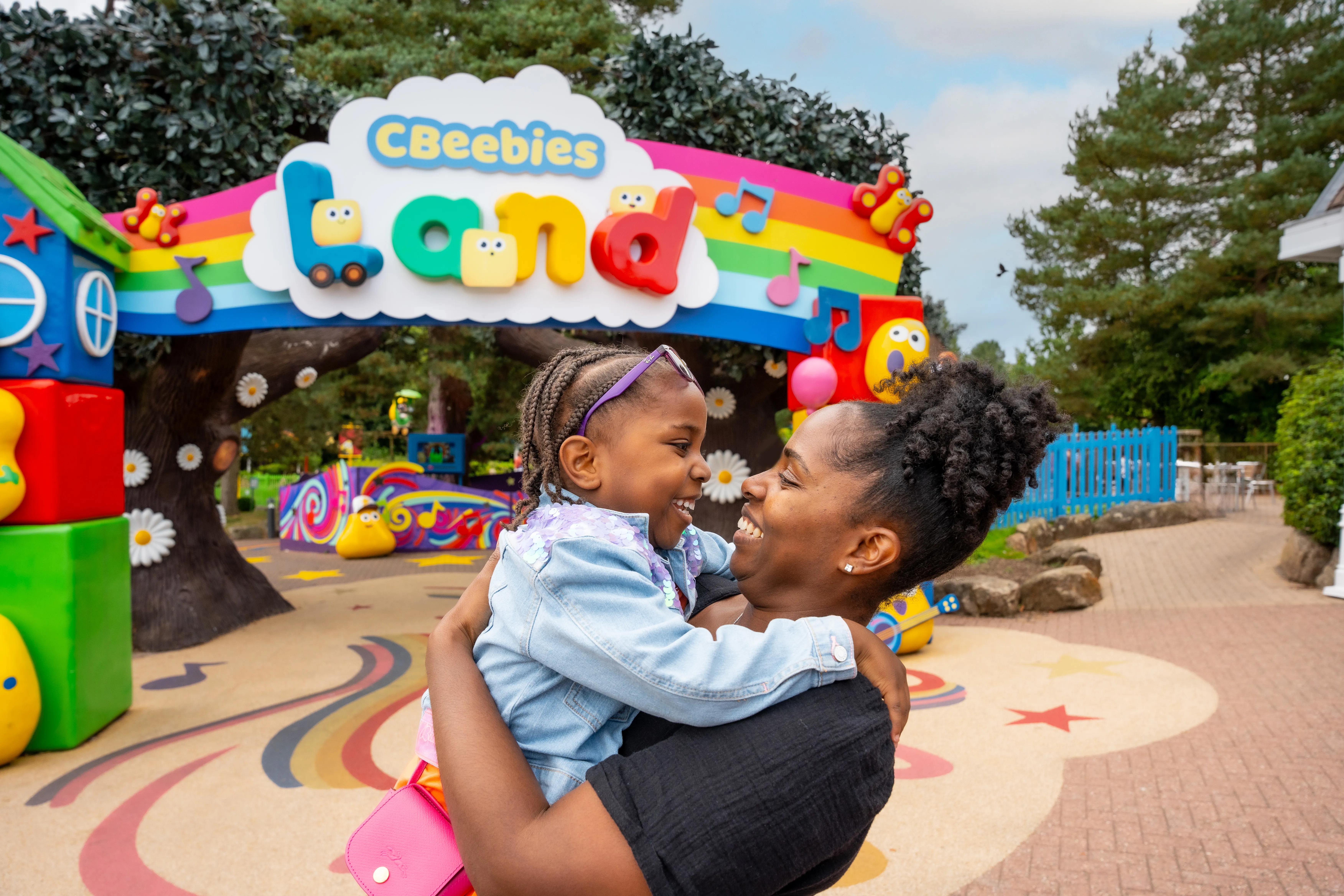 Mother holding daughter in front of CBeebies Land entrance at Alton Towers Resort